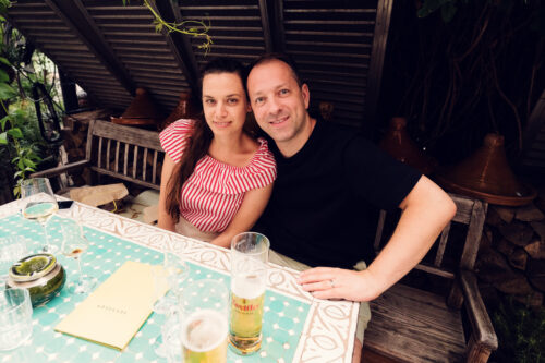 Adriana and Mario enjoying drinks on Lucullus Terrace Vienna with outdoor dining atmosphere and restaurant setting.