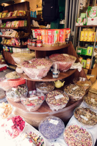 Aromatic tea merchant stand at Naschmarkt's specialty section, where loose-leaf teas from around the world create a sensory experience.