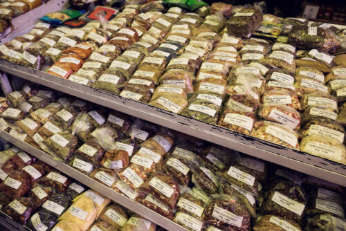 Vibrant spice merchant display at Naschmarkt's international section, where aromatic powders and whole spices create a tapestry of colors and textures.