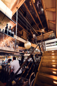 Eclectic design elements at NENI combining industrial warehouse style with warm Oriental touches.