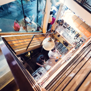 Artistic stairway connecting NENI's dining levels.