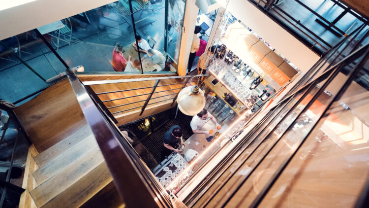 Artistic stairway connecting NENI's dining levels.