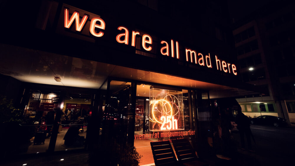 The modern doorway with its distinctive signage and warm lighting creates an inviting gateway to sophisticated dining.