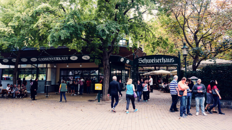 Schweizerhaus's iconic main entrance during peak summer season, where traditional Viennese beer garden culture thrives.