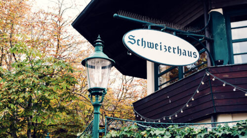 Traditional facade of Schweizerhaus with its characteristic green shutters and historic signage.