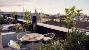 Der Gemeinschaftsloungebereich der Atmosphere Rooftop Bar mit Wiener Designelementen und Skyline-Kulisse.