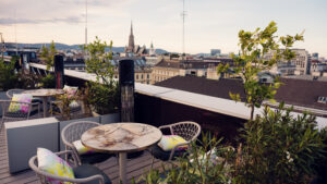 Atmosphere Rooftop Bar's communal lounge area featuring Viennese design elements and skyline backdrop.