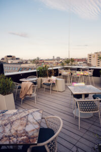 Outdoor terrace of Atmosphere Rooftop Bar Vienna during golden hour, featuring lounge seating.