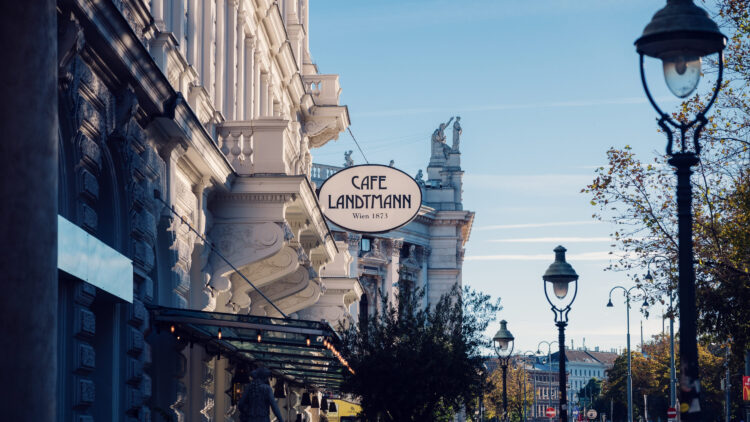 Café Landtmann's Neo-Baroque facade on Universitätsring 4, with its original 1873 architectural details and outdoor seating area facing the Burgtheater.