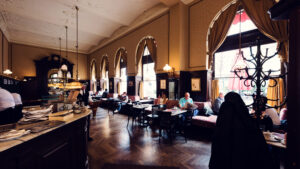Evening atmosphere at Café Sperl illuminated by original chandeliers.