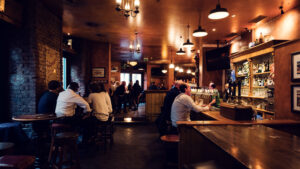 Evening ambiance at Flanagans traditional Irish bar, where dark wood paneling create authentic pub atmosphere.