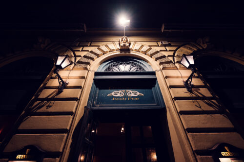 Evening scene at Flanagans entrance, featuring iconic Irish pub signage and traditional lanterns.