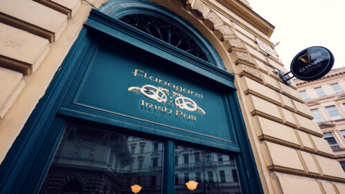 Traditional pub entrance at Flanagans, where vintage signage create classic Irish atmosphere in Vienna's heart.