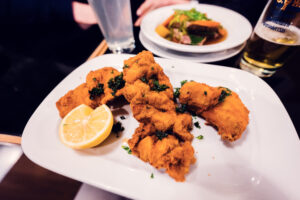 Crispy Backhendl at Gasthaus Pöschl, where golden-brown breaded chicken demonstrates traditional Viennese preparation.