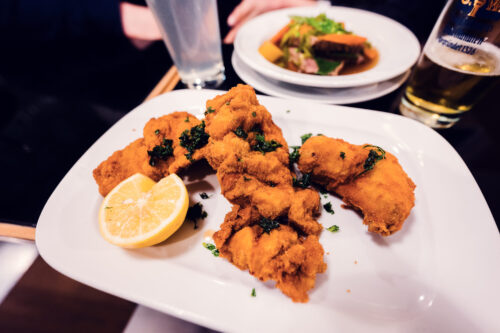 Crispy Backhendl at Gasthaus Pöschl, where golden-brown breaded chicken demonstrates traditional Viennese preparation.