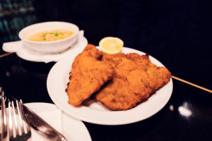 Authentic Wiener Schnitzel at Gasthaus Pöschl, perfectly breaded and served.