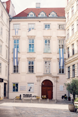 Museum Judenplatz entrance at Jewish Square Vienna, featuring glass facade and information panels about medieval Jewish life.