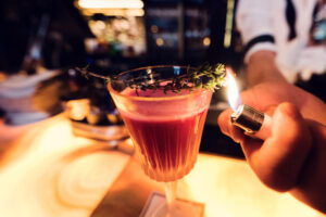Cocktail preparation at Kleinod Bar's marble counter.