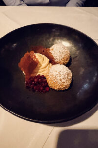 Warm Nougat Knödel (chocolate-filled dumplings) served at Das Turm restaurant in Donauturm Vienna, accompanied by premium vanilla ice cream.