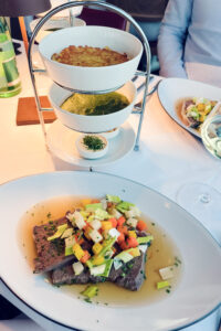 Traditional Viennese Tafelspitz served at Donauturm's revolving restaurant, featuring tender boiled beef with root vegetables and apple horseradish.