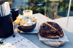 Gourmet sandwich and fries with truffle mayo sauce at Aurora Rooftop Bar Vienna Austria.