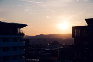 Sunset cityscape from Aurora Rooftop Bar Vienna, elevated evening views with warm golden light casting over Vienna's skyline and urban landscape.