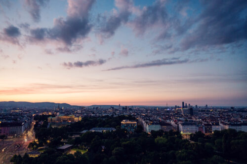 Sunset view from Aurora Rooftop Bar Vienna Austria, golden hour cityscape with panoramic Vienna skyline and evening light over historic city center.