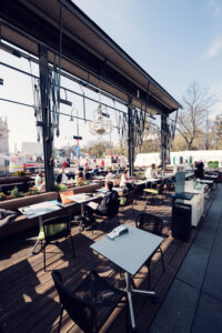 Summer terrace at Café Landtmann Vienna with views of Rathaus and University.