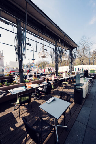 Summer terrace at Café Landtmann Vienna with views of Rathaus and University.