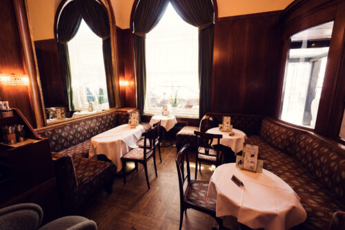 Viennese Coffeehouse Culture with Café Landtmann's grand interior featuring original 1873 design elements.