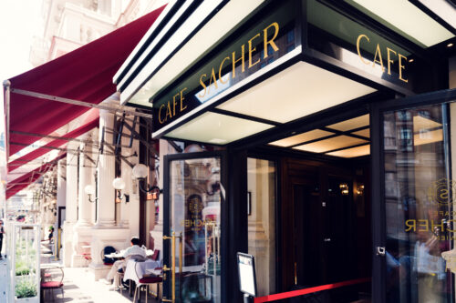 Elegant entrance of Café Sacher Vienna with classic elements.