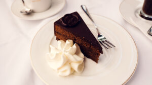 Original Sacher Torte with glossy chocolate glaze, whipped cream and the characteristic Sacher seal.
