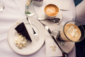 Traditional Sacher Torte on elegant porcelain plate.