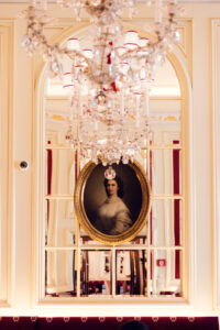 Historic mirrors and portrait of Empress Elisabeth (Sisi) at Café Sacher Vienna.