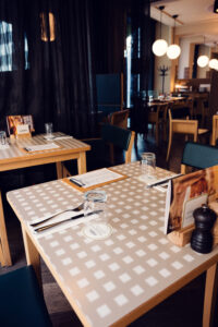 Inside view of Lugeck Figlmüller, traditional Austrian restaurant interior with classic wooden tables and warm dining atmosphere.