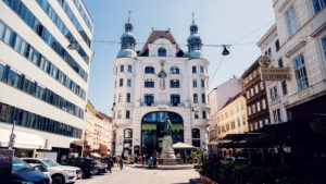 Street view of Lugeck Figlmüller´s exterior, historic Viennese building architecture with traditional restaurant facade and outdoor dining setup in city center.