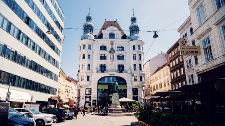 Street view of Lugeck Figlmüller´s exterior, historic Viennese building architecture with traditional restaurant facade and outdoor dining setup in city center.