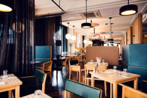 Interior of Lugeck Figlmüller restaurant Vienna Austria, traditional Austrian dining room with wooden tables and classic Viennese gastronomy atmosphere.