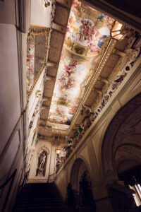 Palais Kinsky Wien baroque interior chamber with ornate ceiling frescoes gilded details and Habsburg period palace decorative architectural elements.