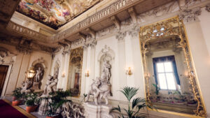 Kinsky Palace Vienna interior baroque sculptures featuring classical marble statuary ornamental bases and Habsburg era palace artistic decorations Vienna Austria.