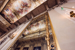 Vienna Kinsky Palace interior baroque grand salon with ornamental ceiling frescoes crystal lighting and Habsburg era palace decorative arts.