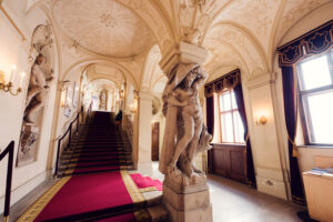 Kinsky Palace Vienna baroque interior staircase featuring marble steps decorative balustrades and ornamental ceiling paintings Habsburg era design.