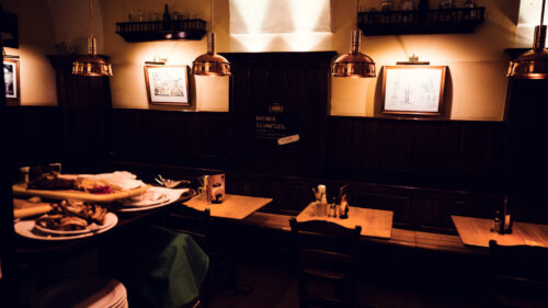 Wiener Salm Bräu interior Vienna with traditional Austrian brewery decor, wooden furnishings and copper brewing equipment, historic Vienna brewery atmosphere.