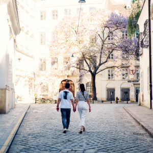 Adriana and Mario walking near Vienna Clock Museum (Uhrenmuseum) in Vienna's First District, historic Inner City street scene.