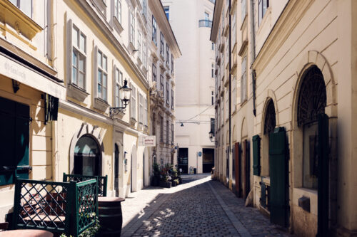 Kurrentgasse narrow cobblestone street in Vienna's First District with historic Baroque and medieval buildings.