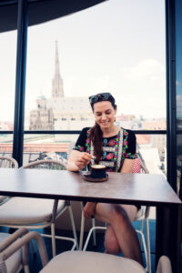 Adriana enjoying coffee at Lamee Rooftop Bar in Vienna.