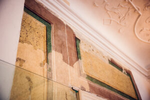 Mozarthaus museum interior with baroque ceiling details and wooden floors.