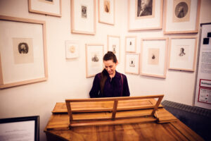 Adriana at historic piano display at Mozarthaus.