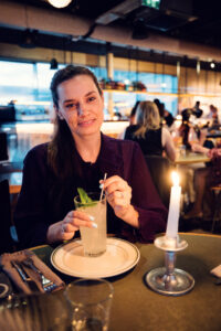 Adriana with homemade lemonade in modern interior dining area at Neni am Prater.