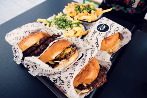 XO Grill Neubaugasse beef burger served with crispy french fries.